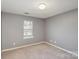 Neutral bedroom featuring carpet, window, and light gray walls at 2249 Cigar Ct, Charlotte, NC 28273