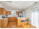 Eat-in kitchen featuring wood cabinets, stainless appliances, and bar seating, perfect for casual dining at 2249 Cigar Ct, Charlotte, NC 28273