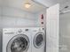 Convenient laundry area equipped with modern washer and dryer, plus shower and storage at 2249 Cigar Ct, Charlotte, NC 28273