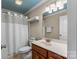 Cozy bathroom features a light blue ceiling and shower with a white shower curtain at 3119 18Th Ne St, Hickory, NC 28601