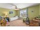 Inviting bedroom with a ceiling fan and bright window overlooking a serene outdoor view at 3119 18Th Ne St, Hickory, NC 28601
