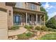 Inviting covered front porch with stone columns and lush landscaping leading to the front door at 3119 18Th Ne St, Hickory, NC 28601