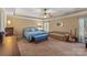Spacious main bedroom featuring a tray ceiling, ceiling fan, and comfortable furnishings at 3119 18Th Ne St, Hickory, NC 28601