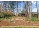 Charming backyard playground is nestled among mature trees and landscaping, perfect for Gathering fun at 3119 18Th Ne St, Hickory, NC 28601