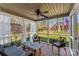Screened porch with comfortable seating provides a relaxing outdoor living space overlooking the landscaped backyard at 3119 18Th Ne St, Hickory, NC 28601