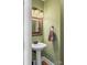 Chic powder room with a pedestal sink, decorative mirror, and soft green walls at 3119 18Th Ne St, Hickory, NC 28601