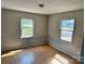 A bright bedroom with two windows overlooking the outdoors and light wood floors at 314 N Little Texas Rd, Kannapolis, NC 28083