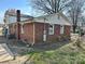 Brick home exterior showing utility connections and partial landscaping at 314 N Little Texas Rd, Kannapolis, NC 28083