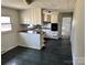Open kitchen layout with white cabinetry, dark countertops, and a peninsula at 314 N Little Texas Rd, Kannapolis, NC 28083