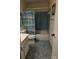 Bathroom with a combination tub and shower, blue tile flooring, and a coordinating striped shower curtain at 319 Vista Grande Cir, Charlotte, NC 28226