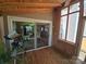 Outdoor deck area adjacent to the sunroom with a view of the dining and kitchen area through a glass door at 319 Vista Grande Cir, Charlotte, NC 28226