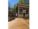 Wooden deck attached to a screened-in porch with a beautiful flower garden at 319 Vista Grande Cir, Charlotte, NC 28226