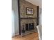 Close-up of the living room's stone fireplace with wooden mantle and decorative accents at 319 Vista Grande Cir, Charlotte, NC 28226