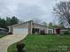 Charming ranch-style home with a two-car garage and beautifully manicured front lawn at 319 Vista Grande Cir, Charlotte, NC 28226