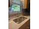Close-up of a stainless steel kitchen sink with modern faucet and bright natural light from the window above at 319 Vista Grande Cir, Charlotte, NC 28226