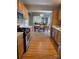 Kitchen area with gas range and stainless steel appliances, leading into the dining room at 319 Vista Grande Cir, Charlotte, NC 28226