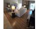 Cozy living room featuring a stone fireplace, wood floors, and neutral-toned furnishings at 319 Vista Grande Cir, Charlotte, NC 28226