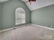 Bright, empty bedroom featuring vaulted ceiling and large window at 3865 Granite St, Terrell, NC 28682