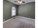Empty bedroom with neutral carpet, large window, and fresh paint at 3865 Granite St, Terrell, NC 28682