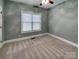 Neutral bedroom with plush carpet, a window, and a door at 3865 Granite St, Terrell, NC 28682
