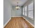 A dining room featuring hardwood floors, a chandelier, and three windows providing ample natural light at 3865 Granite St, Terrell, NC 28682