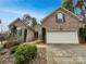 Charming brick home featuring a manicured front yard and a two-car garage at 3865 Granite St, Terrell, NC 28682