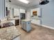 Bright kitchen with gray cabinets, island, granite countertops and stainless steel appliances at 3865 Granite St, Terrell, NC 28682