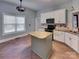Bright kitchen with island, white cabinets, granite countertops, and stainless steel appliances at 3865 Granite St, Terrell, NC 28682