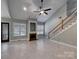 Spacious living room showcasing tiled floors, fireplace, and staircase at 3865 Granite St, Terrell, NC 28682