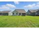Manicured backyard featuring well-maintained lawn and view of neighboring houses at 4009 Grace Pointe Dr # 101, Indian Trail, NC 28079