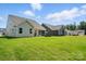 Lush backyard and neighboring homes; well-kept lawn extending to the back boundaries at 4009 Grace Pointe Dr # 101, Indian Trail, NC 28079