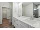 Bathroom with dual sinks, quartz counters, and open doorway to linen closet at 4009 Grace Pointe Dr # 101, Indian Trail, NC 28079
