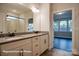 A bathroom with double sinks, granite countertops, and a view to a bedroom through the open door at 4009 Grace Pointe Dr # 101, Indian Trail, NC 28079