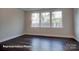 Bright bedroom with three windows, hardwood floors, and a scenic view at 4009 Grace Pointe Dr # 101, Indian Trail, NC 28079