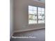 A bedroom with a large window that offers views of the neighborhood at 4009 Grace Pointe Dr # 101, Indian Trail, NC 28079