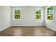 Bedroom featuring wood-look floors, white trim, and multiple windows at 4009 Grace Pointe Dr # 101, Indian Trail, NC 28079