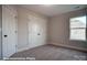 Bedroom featuring plush carpet, a large window, and double door closet at 4009 Grace Pointe Dr # 101, Indian Trail, NC 28079