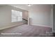 Bonus room featuring a large window, plush carpeting and neutral paint at 4009 Grace Pointe Dr # 101, Indian Trail, NC 28079