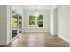 Dining area with large windows, natural light, and wood-look floors at 4009 Grace Pointe Dr # 101, Indian Trail, NC 28079
