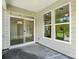 Exterior view featuring a sliding glass door, large windows, and access to the backyard at 4009 Grace Pointe Dr # 101, Indian Trail, NC 28079