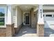 Close-up of the front door with brick accents and pillars, recessed lighting and visible house number at 4009 Grace Pointe Dr # 101, Indian Trail, NC 28079
