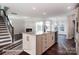 Spacious kitchen island in an open-concept living space with dark hardwood flooring at 4009 Grace Pointe Dr # 101, Indian Trail, NC 28079
