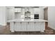 Modern white kitchen with a large center island, stainless steel appliances, and pendant lighting at 4009 Grace Pointe Dr # 101, Indian Trail, NC 28079