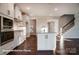 Open kitchen layout featuring a center island, white cabinets, and staircase access at 4009 Grace Pointe Dr # 101, Indian Trail, NC 28079