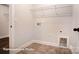 Bright laundry room with overhead wire shelving, tile floor, and convenient utility connections at 4009 Grace Pointe Dr # 101, Indian Trail, NC 28079