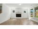 Bright living room with a fireplace, large windows and hard wood flooring at 4009 Grace Pointe Dr # 101, Indian Trail, NC 28079