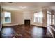 Open living area featuring abundant natural light, fireplace, and dark hardwood floors at 4009 Grace Pointe Dr # 101, Indian Trail, NC 28079
