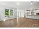 Open floorplan with wood-look flooring and bright natural light at 4009 Grace Pointe Dr # 101, Indian Trail, NC 28079