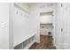 Convenient mud room features hooks, bench with cubbies, and laundry room access at 4009 Grace Pointe Dr # 101, Indian Trail, NC 28079