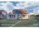 Back of house showing a well-manicured lawn and covered patio, perfect for outdoor entertaining at 4009 Grace Pointe Dr # 101, Indian Trail, NC 28079